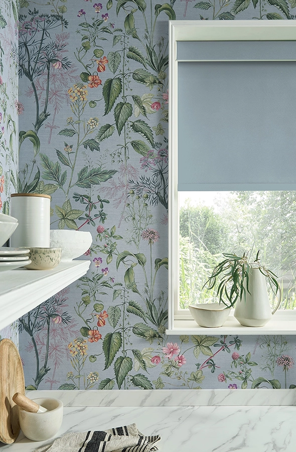 Room with light blue roller blind and flower wallpaper from Graham & Brown