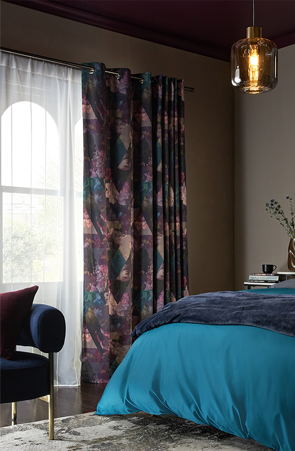 Room with purple geometric curtains and wallpaper from Graham & Brown
