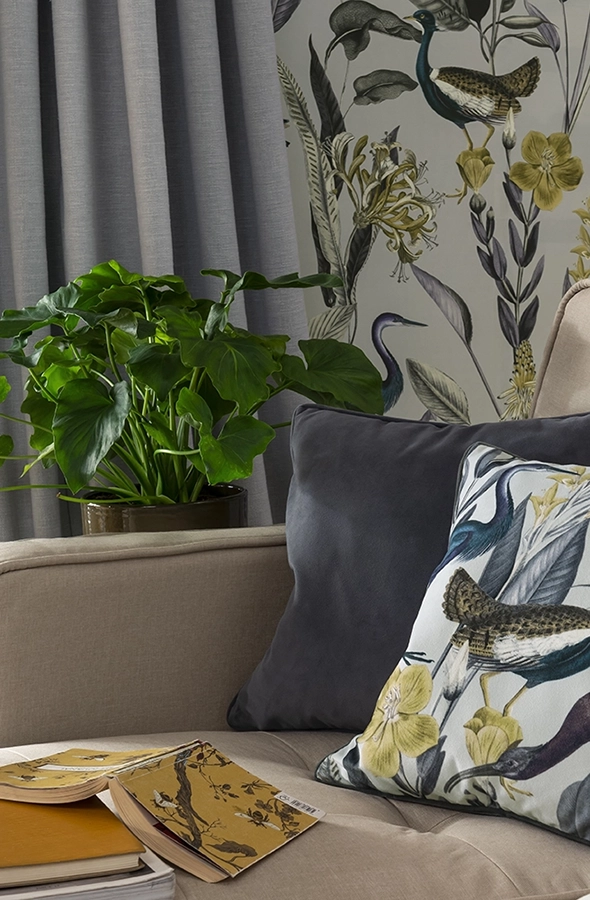 Room with plain grey curtain and flower design cushion from Graham & Brown