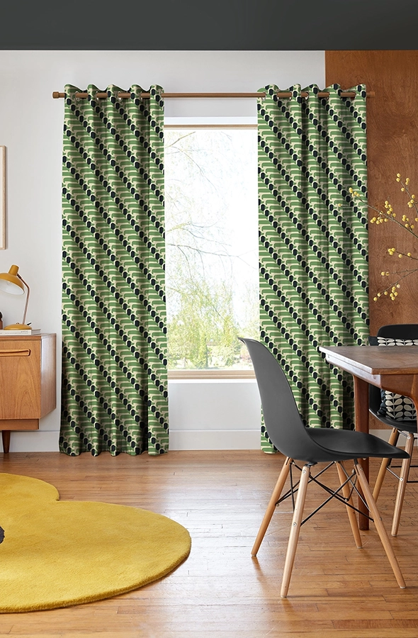 Room with green dog design of curtains from Orla Kiely