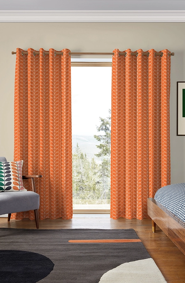 Room with orange geometric design curtains from Orla Kiely