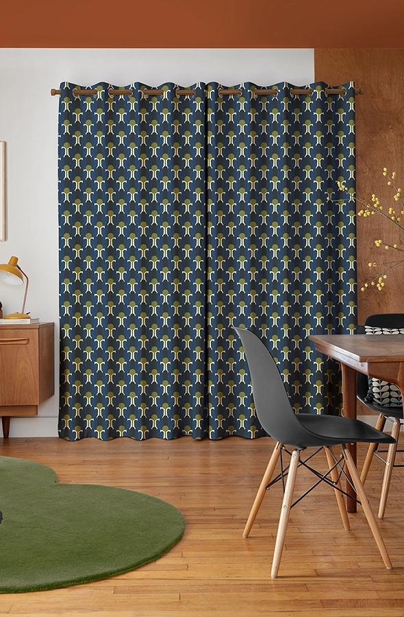 Room with purple flower curtains form Orla Kiely