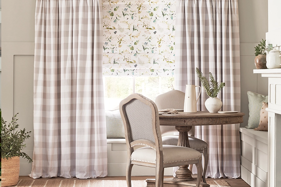 Room with white floral roman blind and check design curtains from Sophie Allport